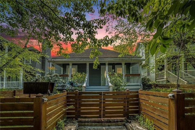 view of front facade featuring a porch and fence