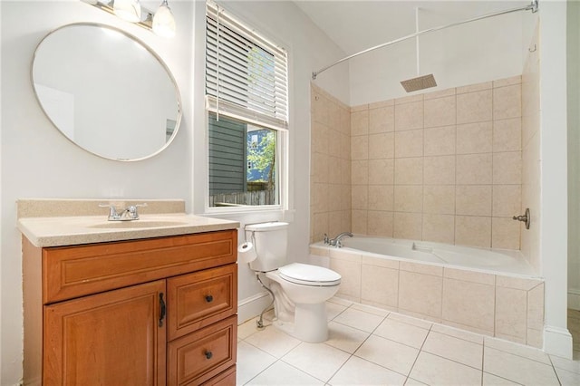 bathroom featuring toilet, tile patterned floors, vanity, and tiled shower / bath