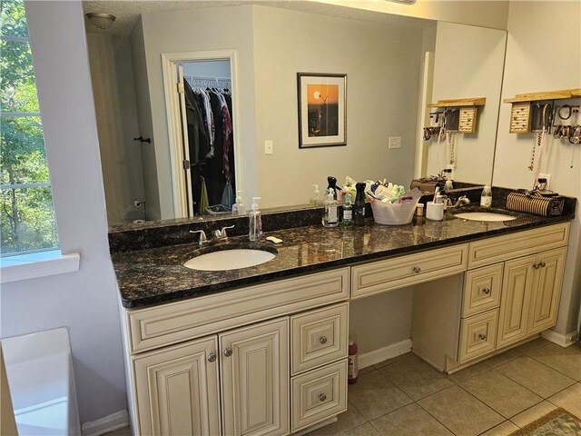 bathroom with tile patterned flooring and vanity