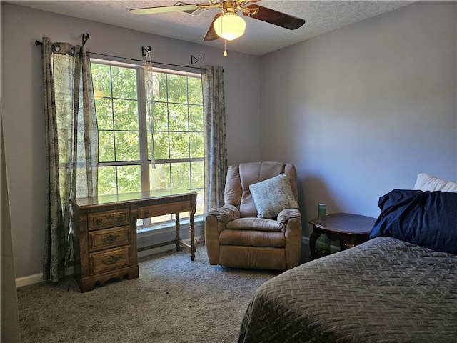 carpeted bedroom with a textured ceiling and ceiling fan