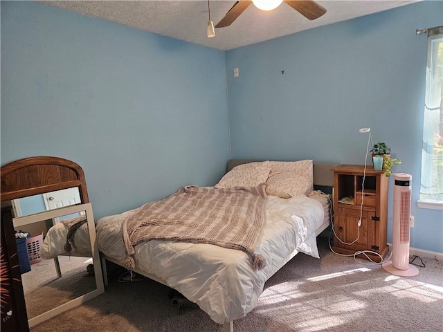 carpeted bedroom featuring a textured ceiling and ceiling fan