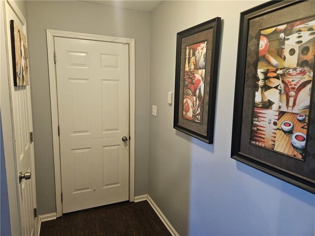 hallway with dark wood-type flooring