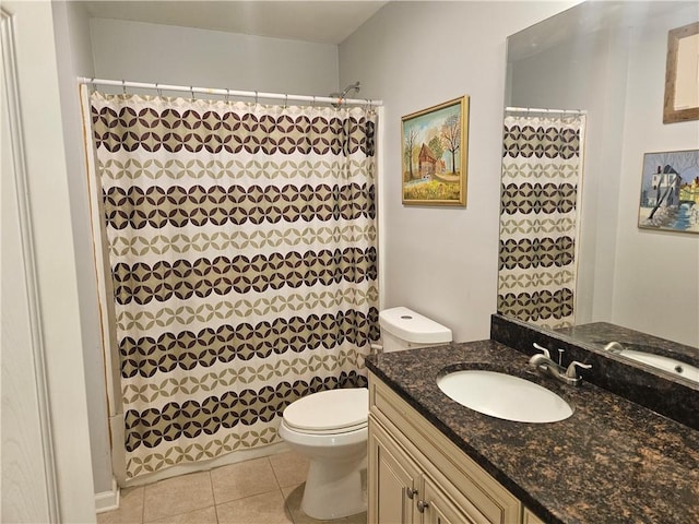 bathroom featuring vanity, a shower with shower curtain, tile patterned floors, and toilet