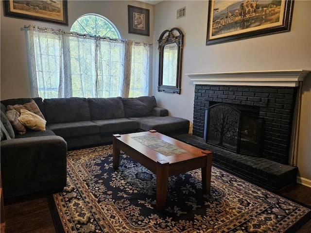 living room featuring a fireplace and dark hardwood / wood-style flooring