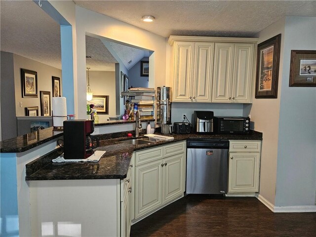 kitchen with a textured ceiling, sink, dishwasher, kitchen peninsula, and dark stone countertops