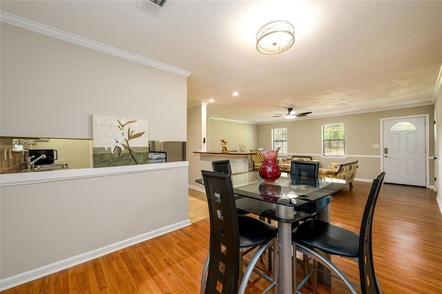 3645 Shrewsbury Ct, Snellville, GA 30039 - dining space with crown molding, wood finished floors, and a ceiling fan
