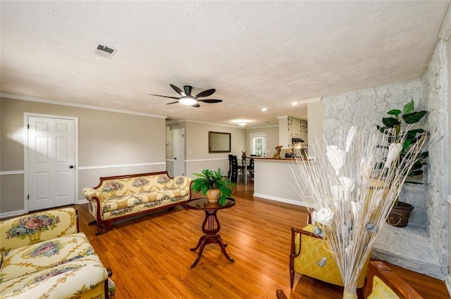 3645 Shrewsbury Ct, Snellville, GA 30039 - living area featuring a textured ceiling, wood finished floors, ceiling fan, and crown molding