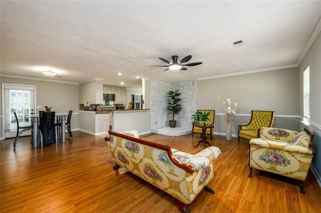 3645 Shrewsbury Ct, Snellville, GA 30039 - living area with a textured ceiling, plenty of natural light, wood finished floors, a ceiling fan, and crown molding