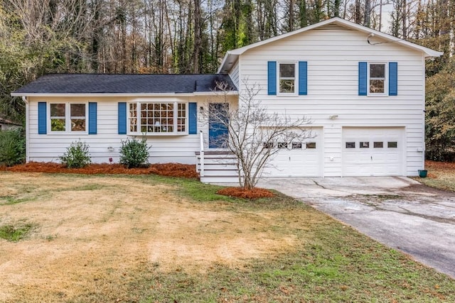 split level home featuring a front yard and a garage