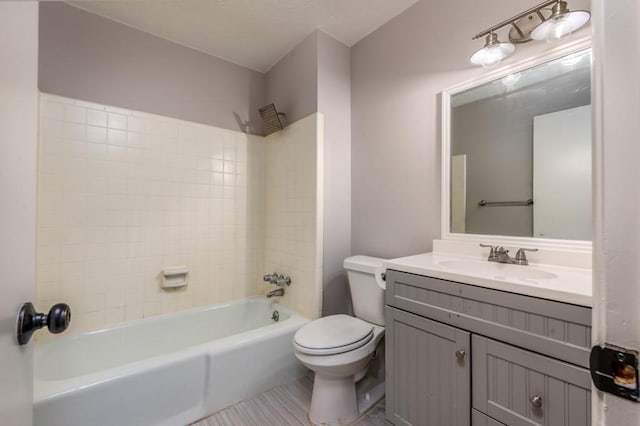 full bathroom with tile patterned flooring, vanity, toilet, and tiled shower / bath