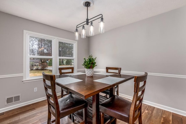 dining space with dark hardwood / wood-style floors