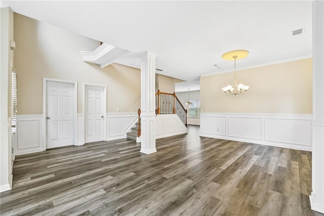 1212 Ashton Park Dr, Lawrenceville, GA 30045 - spare room with a chandelier, wood finished floors, stairs, a wainscoted wall, and a decorative wall