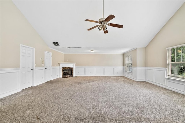 1212 Ashton Park Dr, Lawrenceville, GA 30045 - unfurnished living room with carpet, a ceiling fan, wainscoting, a high end fireplace, and high vaulted ceiling