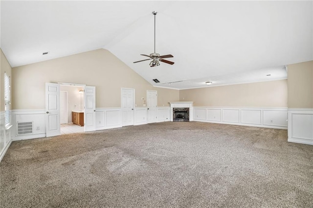 1212 Ashton Park Dr, Lawrenceville, GA 30045 - unfurnished living room with a ceiling fan, a wainscoted wall, a decorative wall, light carpet, and vaulted ceiling