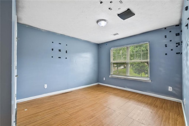 1212 Ashton Park Dr, Lawrenceville, GA 30045 - unfurnished room featuring wood finished floors, a textured ceiling, and baseboards