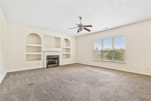1212 Ashton Park Dr, Lawrenceville, GA 30045 - unfurnished living room featuring baseboards, carpet flooring, a fireplace, built in shelves, and ceiling fan