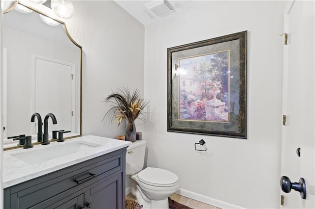 bathroom featuring tile patterned flooring, vanity, and toilet