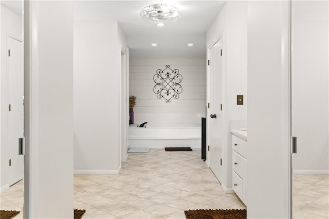 bathroom with vanity and a tub to relax in