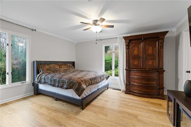 bedroom featuring ornamental molding, ceiling fan, and light wood-type flooring