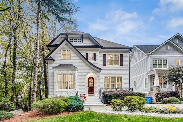 shingle-style home featuring a shingled roof