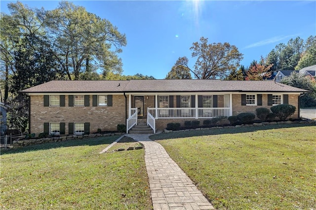 single story home with a front lawn and brick siding