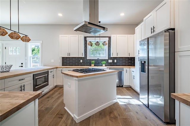 754 Fayetteville Rd SE, Atlanta, GA 30316 - kitchen featuring butcher block countertops, appliances with stainless steel finishes, wood finished floors, white cabinetry, and backsplash