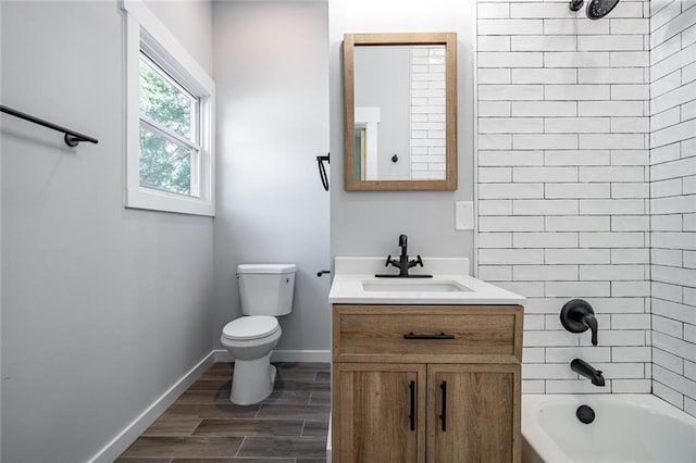 754 Fayetteville Rd SE, Atlanta, GA 30316 - bathroom with vanity, toilet, tub / shower combination, baseboards, and wood finished floors