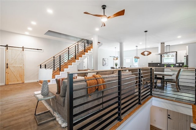 754 Fayetteville Rd SE, Atlanta, GA 30316 - stairs featuring a barn door, a ceiling fan, wood finished floors, recessed lighting, and baseboards