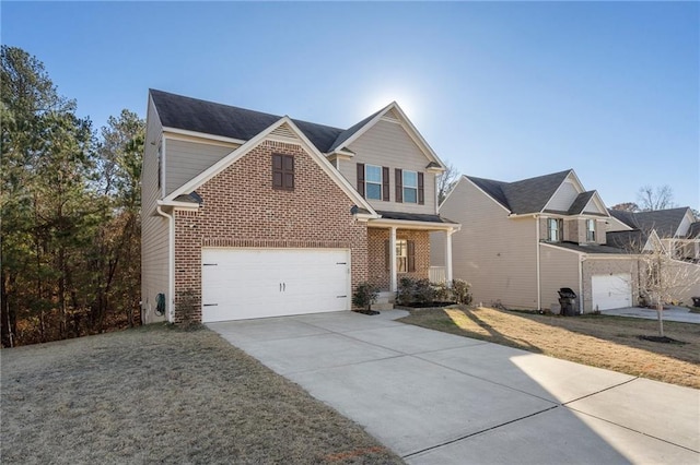 traditional-style house with a garage, a front yard, brick siding, and driveway