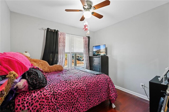 bedroom with dark hardwood / wood-style floors and ceiling fan