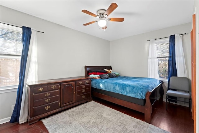 bedroom with ceiling fan and dark hardwood / wood-style flooring