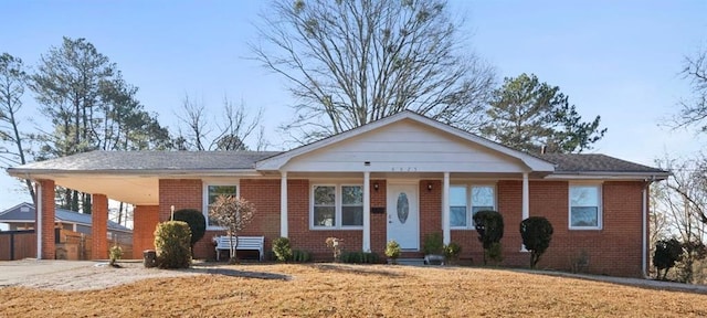 single story home featuring a front yard and brick siding