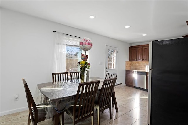 dining space with recessed lighting and baseboards