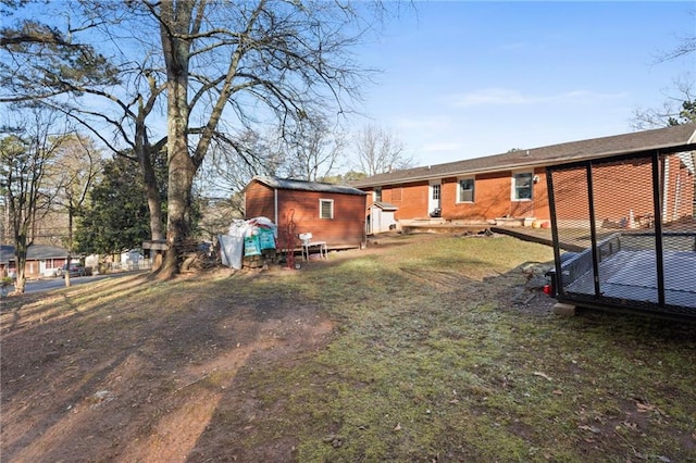 back of house featuring a storage shed