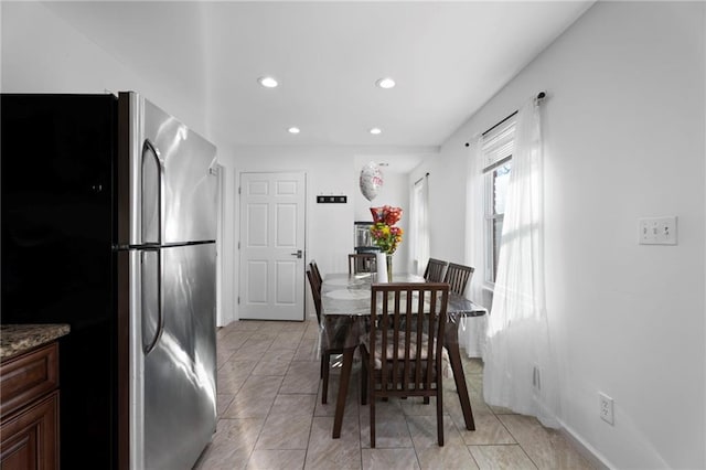 dining room with recessed lighting and light tile patterned flooring