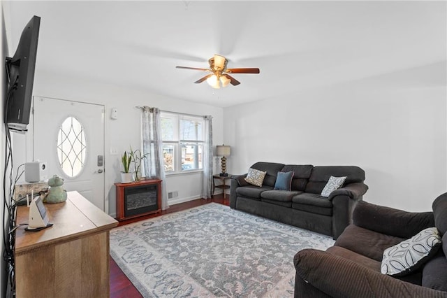 living room featuring hardwood / wood-style flooring and ceiling fan