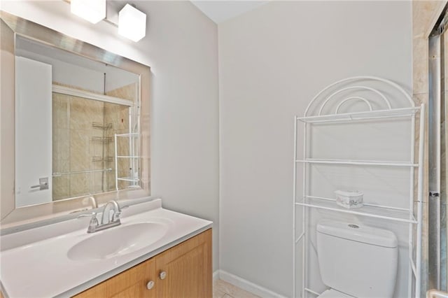 full bath with toilet, a tile shower, and vanity