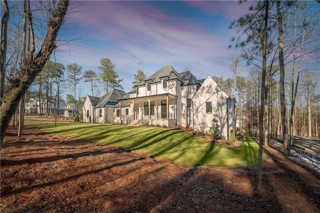 view of front of home with stucco siding and a front lawn