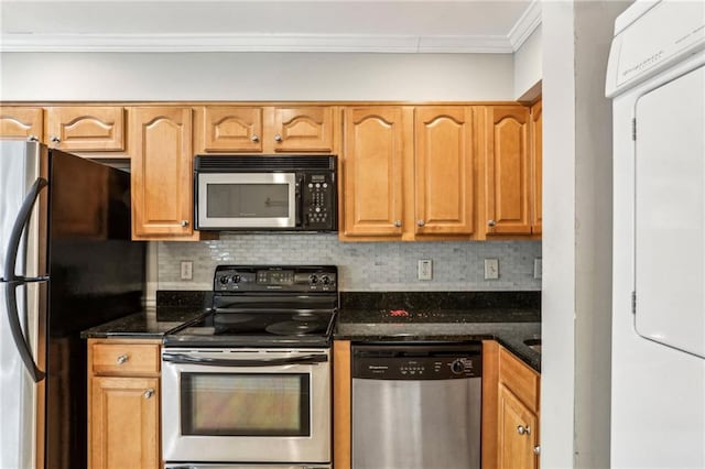 kitchen featuring decorative backsplash, ornamental molding, stainless steel appliances, and dark stone counters