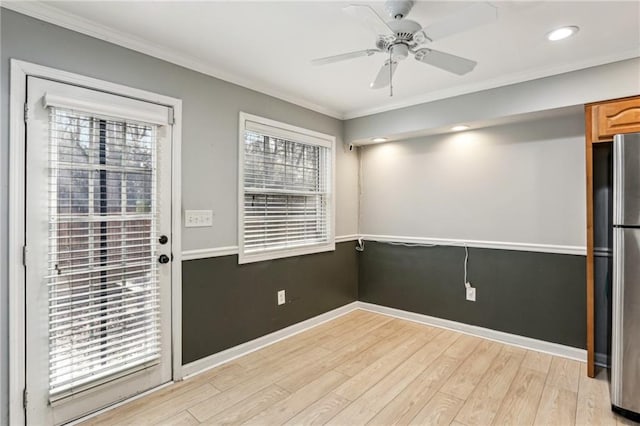 interior space featuring crown molding, light hardwood / wood-style flooring, and ceiling fan