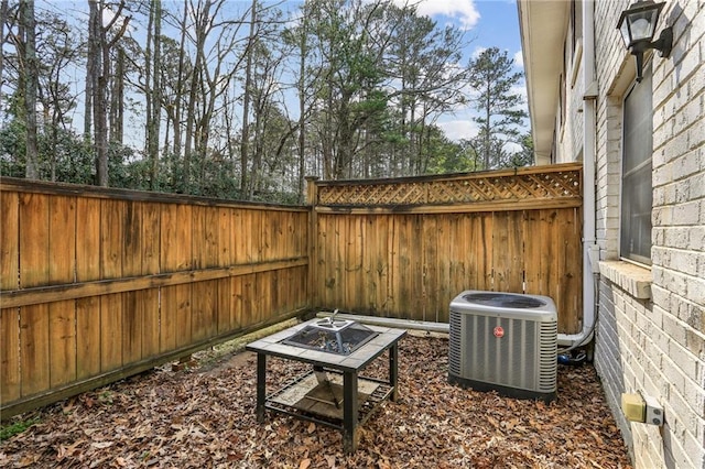 view of patio / terrace with central AC and a fire pit