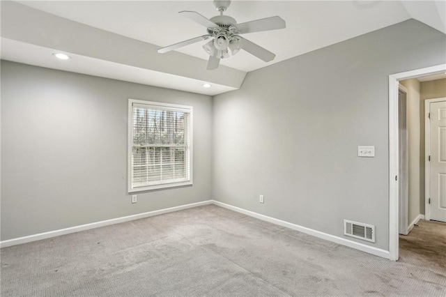 carpeted empty room with ceiling fan and lofted ceiling