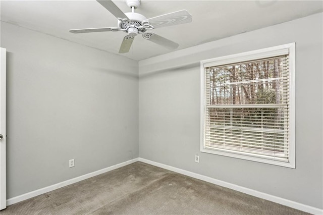 carpeted empty room featuring ceiling fan