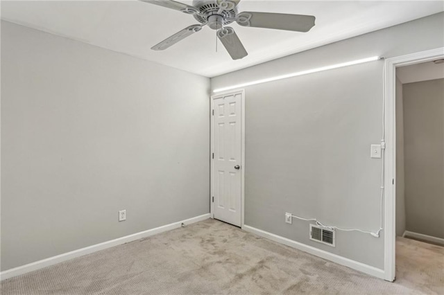 empty room with light colored carpet and ceiling fan