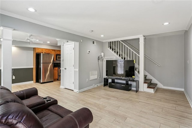 living room with crown molding, ceiling fan, and light hardwood / wood-style flooring