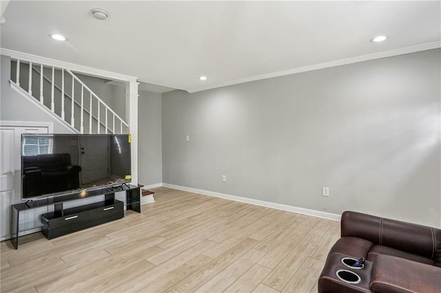 living room with crown molding and light hardwood / wood-style floors