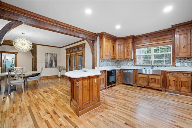 kitchen featuring dishwasher, a sink, brown cabinets, oven, and ornamental molding