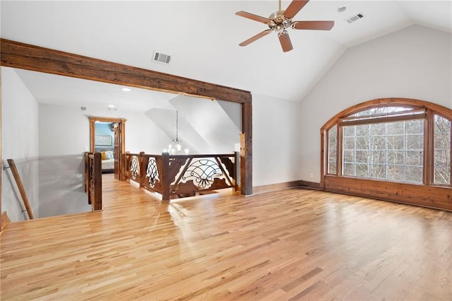 additional living space with lofted ceiling, wood finished floors, a ceiling fan, and a chandelier