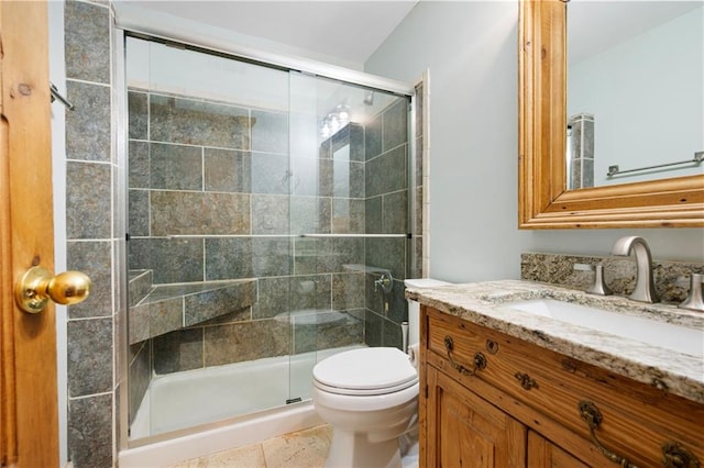 full bath featuring a stall shower, toilet, and vanity