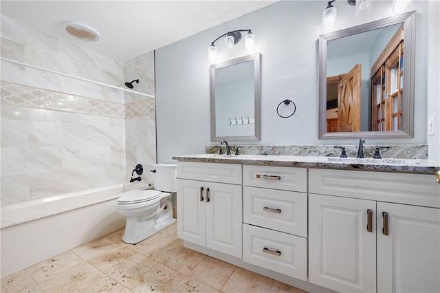 bathroom featuring toilet, shower / bathtub combination, and double vanity